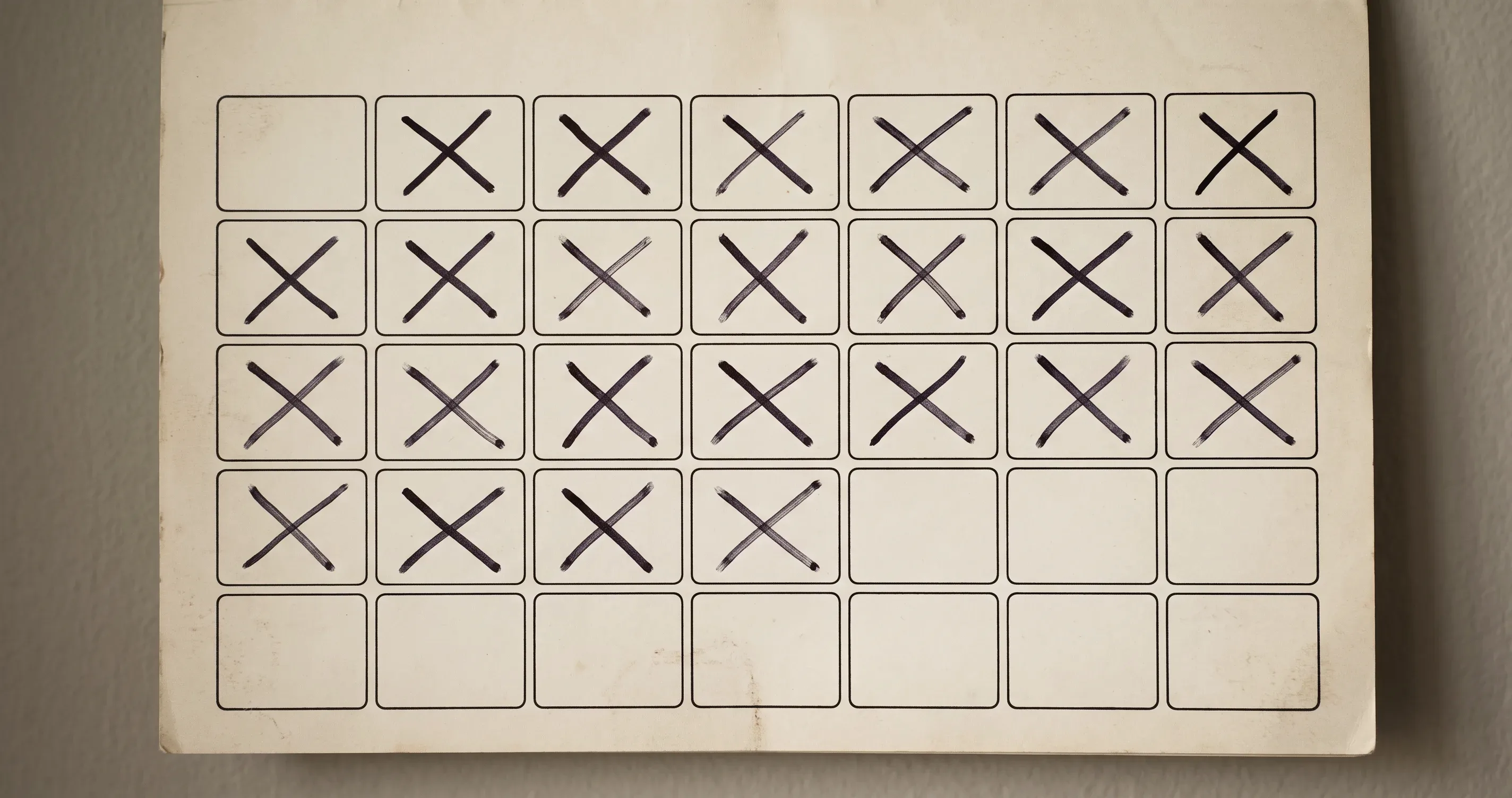 A wall calendar with a run of days marked, and one day left blank.