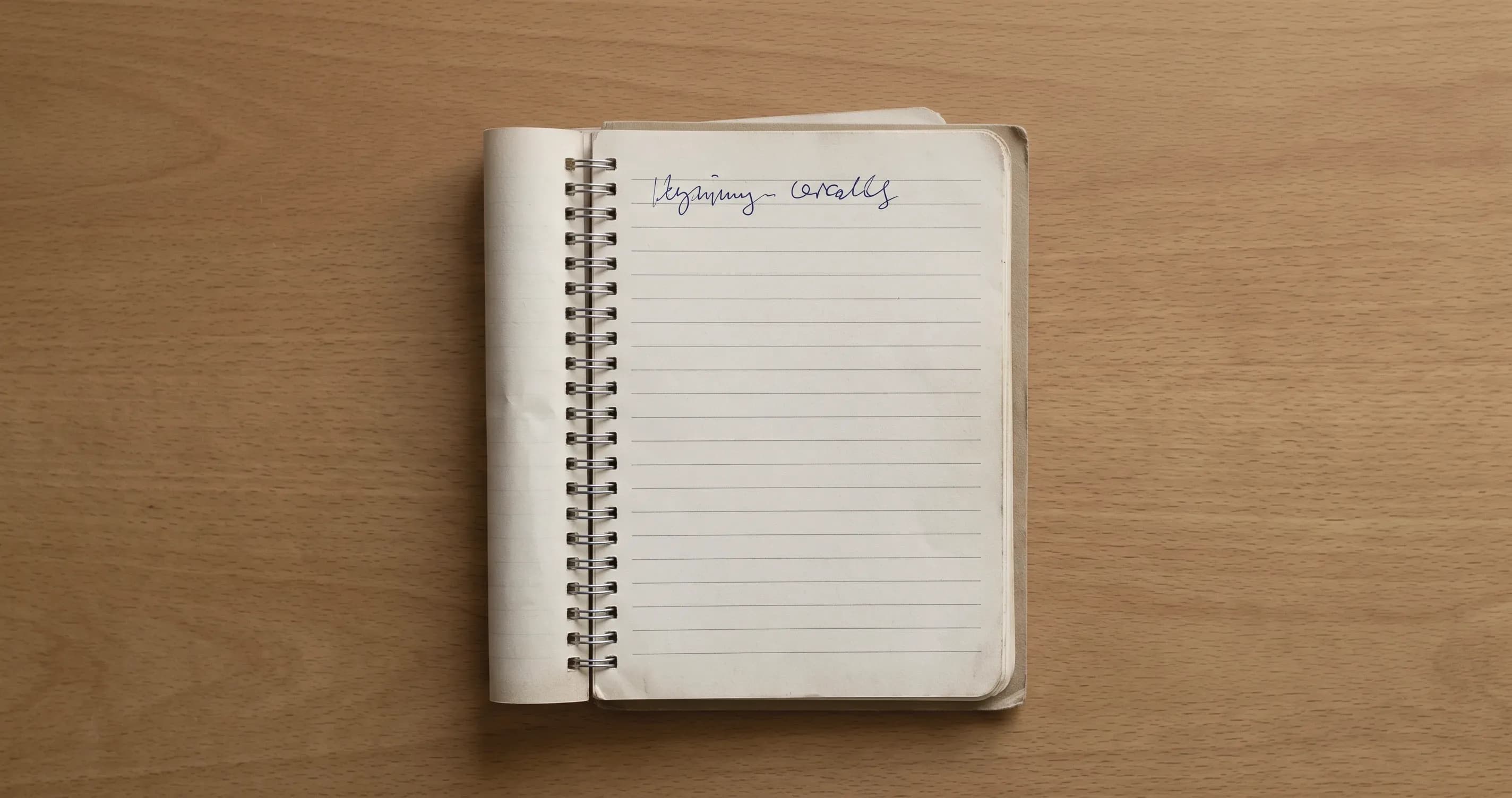 A notebook page with a single short line written at the top and the rest blank.